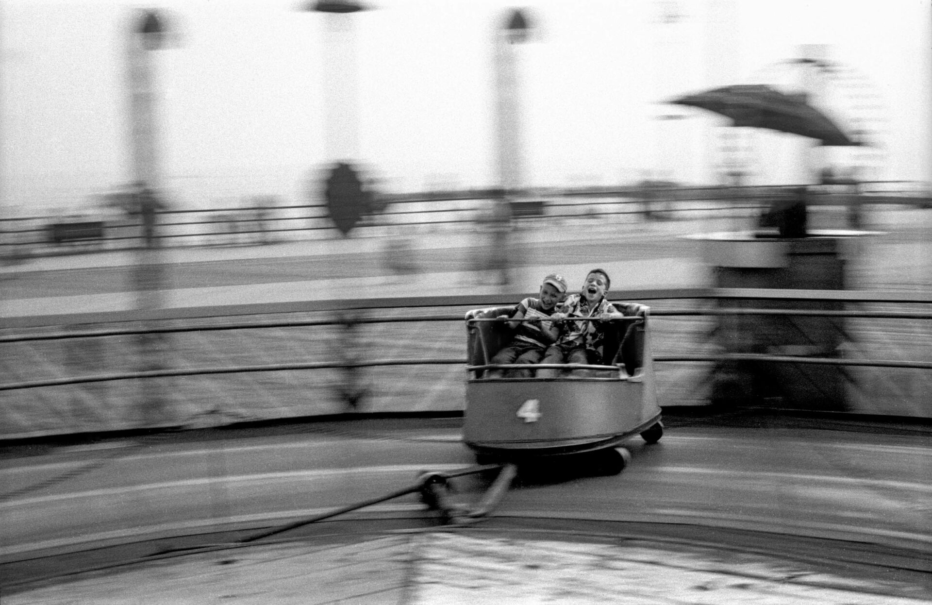 Two little boys are spinning very fast on The Whip, a fun ride in Coney Island in 1950.